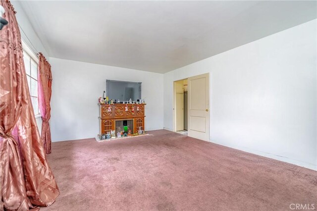 unfurnished living room featuring carpet flooring