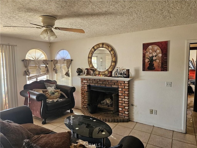 living room featuring ceiling fan, light tile patterned floors, and a textured ceiling