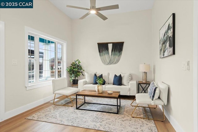 living room with ceiling fan and hardwood / wood-style flooring