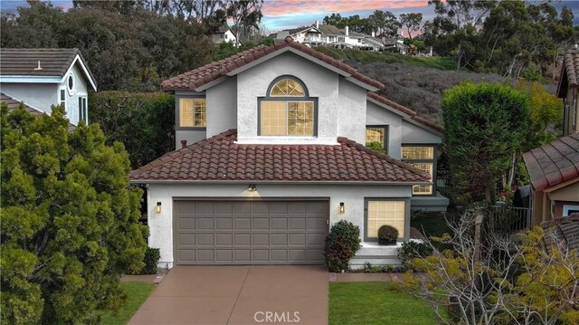 mediterranean / spanish-style house with a garage