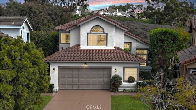 mediterranean / spanish-style home with a garage