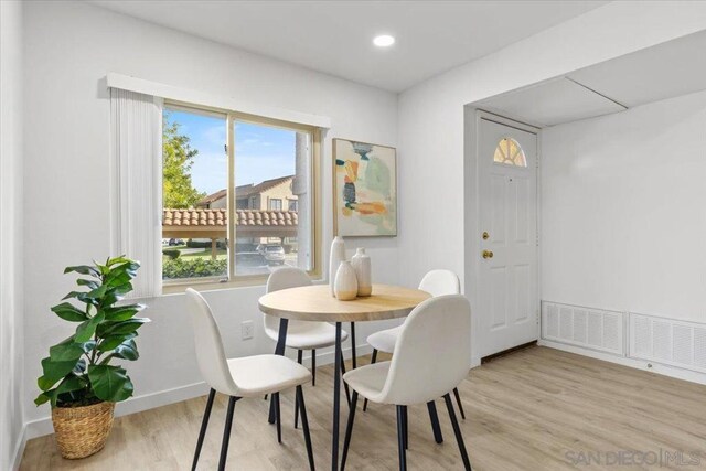 dining space with light hardwood / wood-style floors