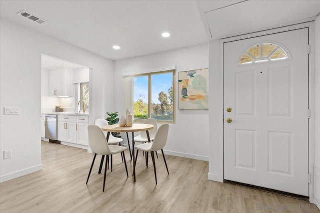 dining space with light hardwood / wood-style floors