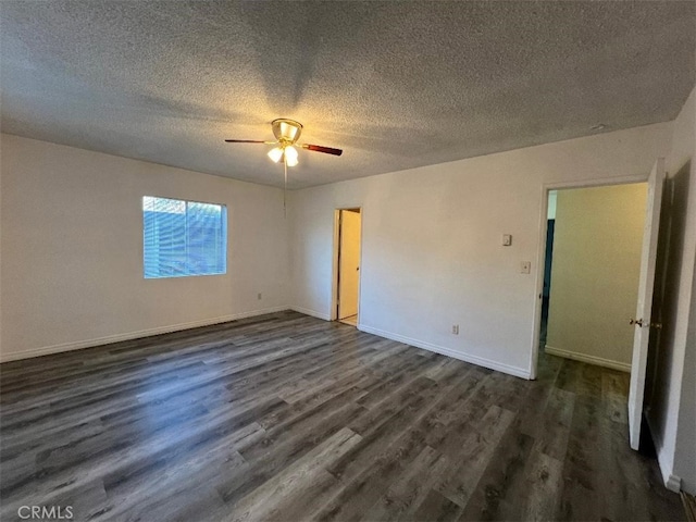 empty room featuring ceiling fan, dark hardwood / wood-style floors, and a textured ceiling