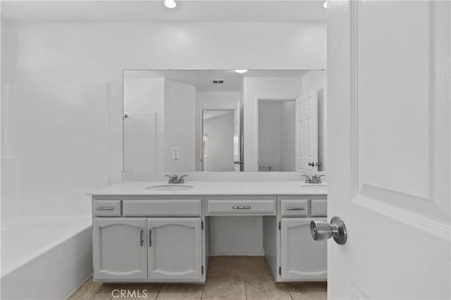 bathroom with tile patterned flooring and vanity