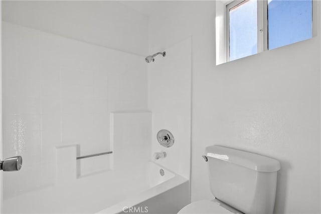 bathroom featuring shower / bathtub combination and toilet