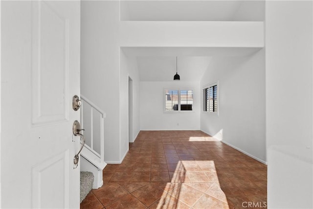 tiled foyer with lofted ceiling