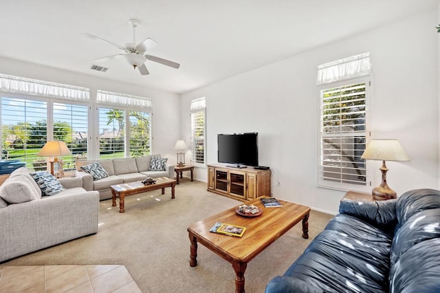 living room with ceiling fan and tile patterned flooring