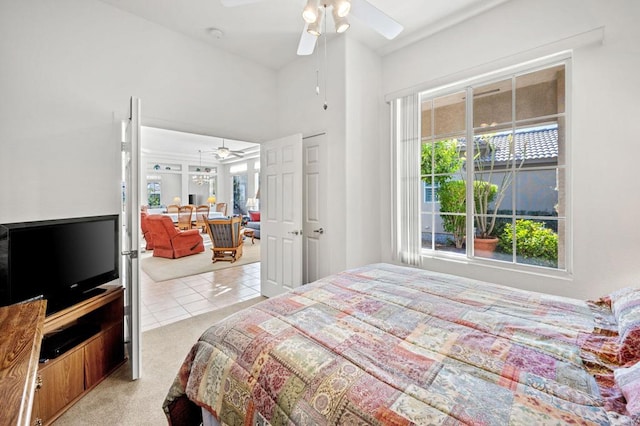 bedroom with ceiling fan and light colored carpet