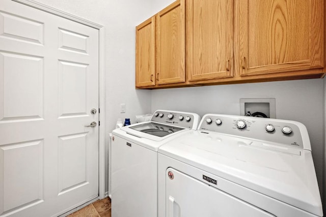 washroom featuring washer and clothes dryer, tile patterned floors, and cabinets