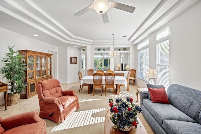 living room featuring ceiling fan with notable chandelier