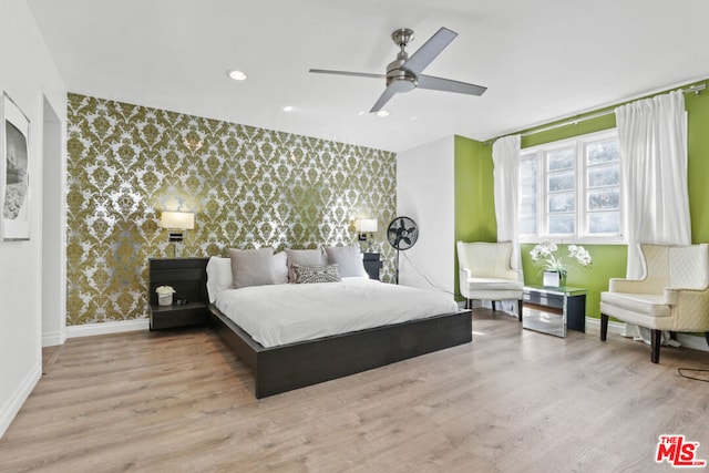 bedroom featuring ceiling fan and light hardwood / wood-style floors