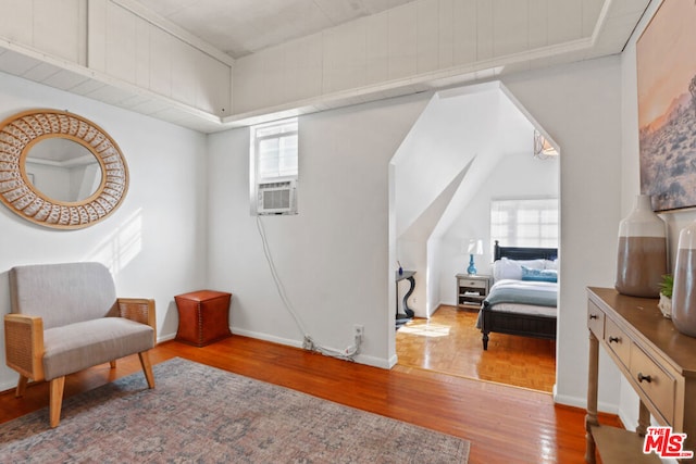 living area with cooling unit and light hardwood / wood-style flooring