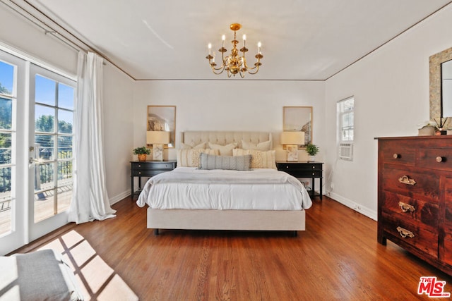 bedroom featuring an inviting chandelier, access to exterior, and dark hardwood / wood-style floors