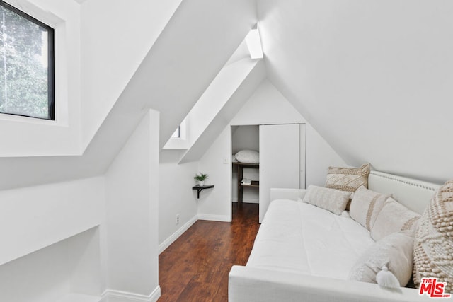 bedroom with dark wood-type flooring and lofted ceiling