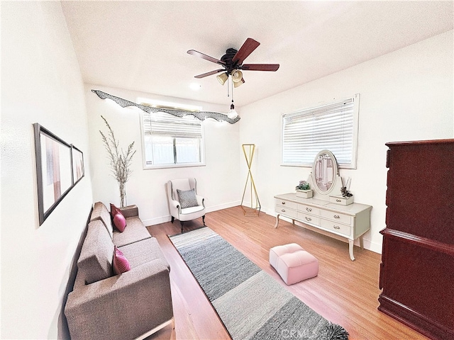 living room with ceiling fan and wood-type flooring