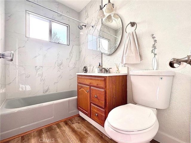 full bathroom with toilet, tiled shower / bath combo, vanity, and hardwood / wood-style flooring