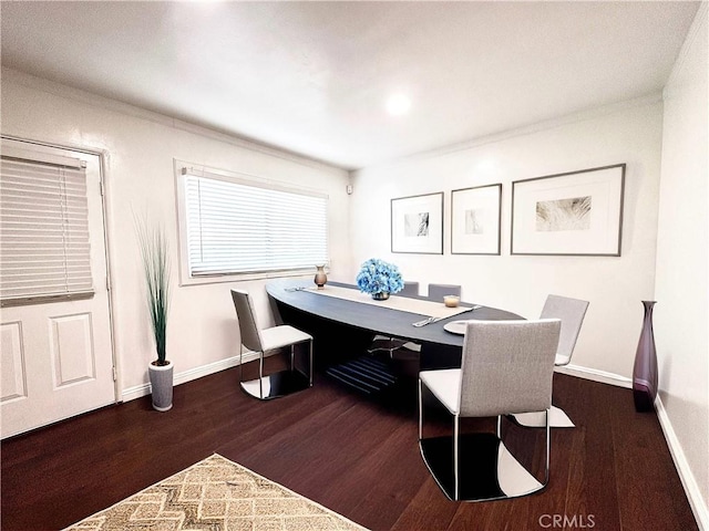 dining room featuring dark wood-type flooring and ornamental molding