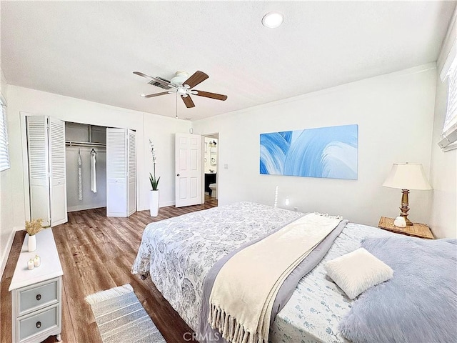 bedroom featuring ceiling fan, a closet, and hardwood / wood-style flooring