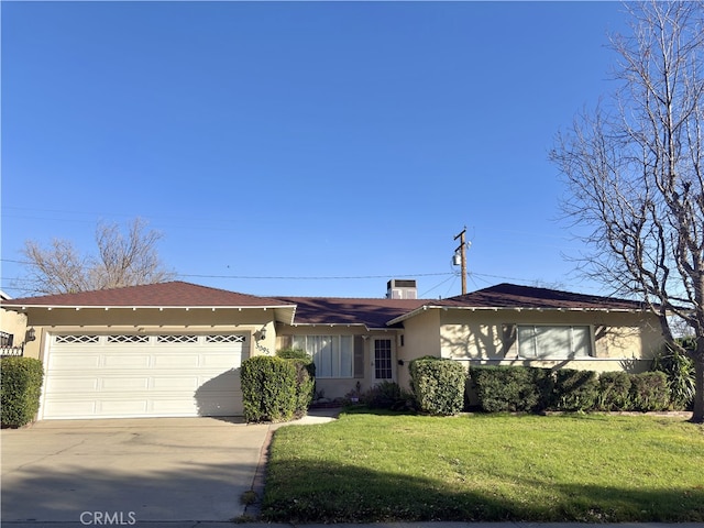 ranch-style house featuring a front lawn and a garage