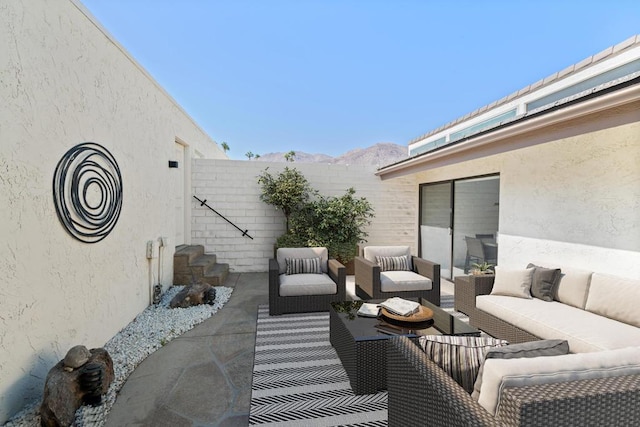 view of patio with a mountain view and an outdoor hangout area