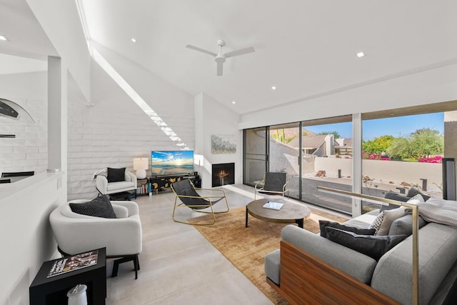 living room with ceiling fan and vaulted ceiling