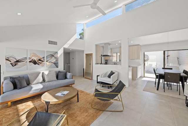 living room featuring ceiling fan and high vaulted ceiling