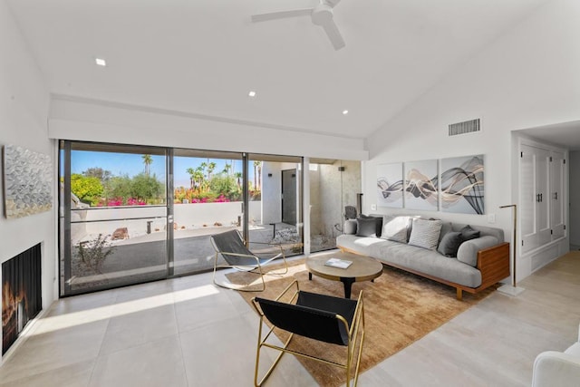 living room featuring ceiling fan and high vaulted ceiling