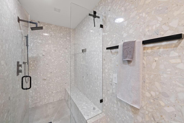 bathroom with a shower with door