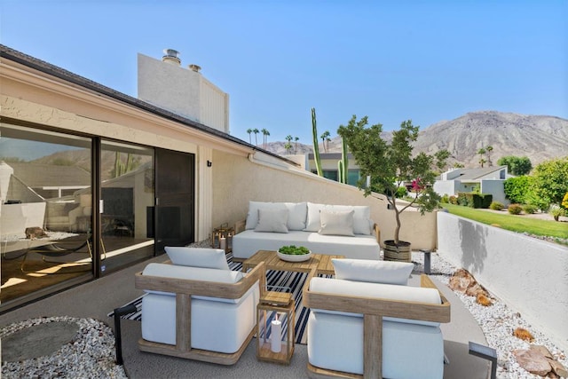 view of patio featuring an outdoor hangout area and a mountain view