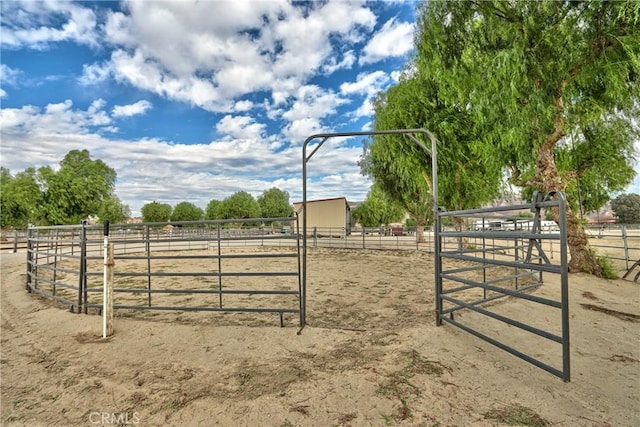 view of gate with a rural view