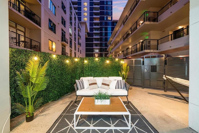 patio terrace at dusk featuring outdoor lounge area