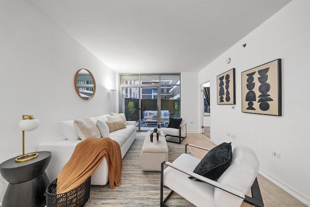 living room with floor to ceiling windows and hardwood / wood-style floors