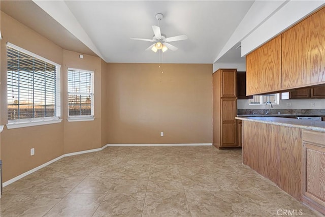 kitchen with ceiling fan, light tile patterned floors, and sink