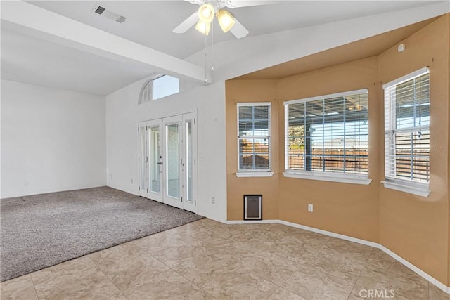 empty room featuring ceiling fan, light carpet, lofted ceiling with beams, and french doors