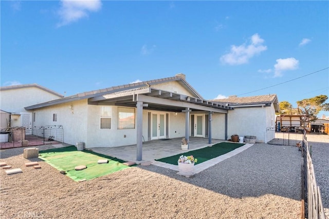 view of front of house with a patio area and french doors