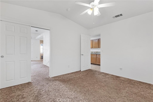 unfurnished room with ceiling fan, carpet, and lofted ceiling