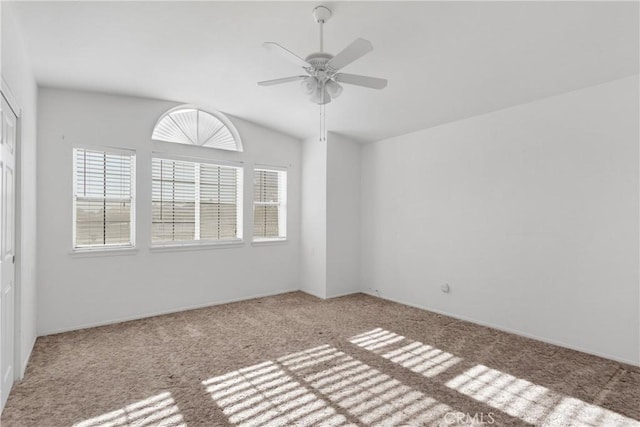 carpeted spare room with ceiling fan