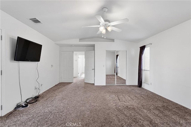 unfurnished bedroom featuring ceiling fan, carpet floors, and vaulted ceiling