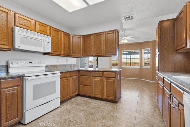 kitchen featuring ceiling fan, light tile patterned flooring, kitchen peninsula, and white appliances