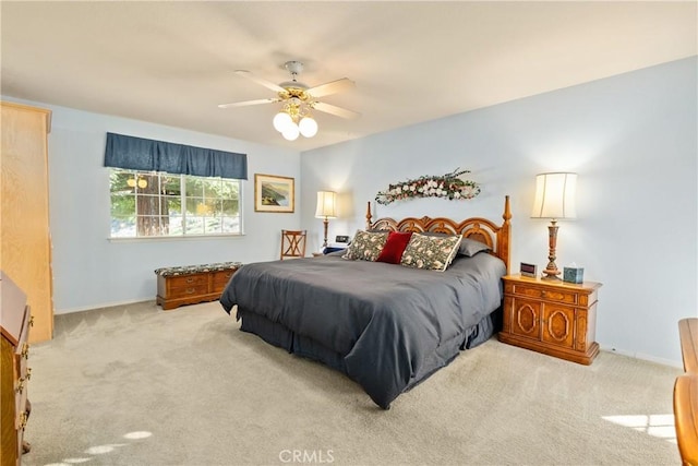 bedroom featuring ceiling fan and light carpet