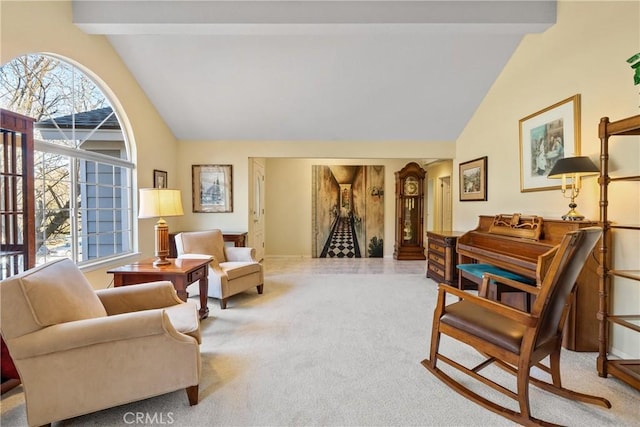 living area with light carpet and vaulted ceiling with beams