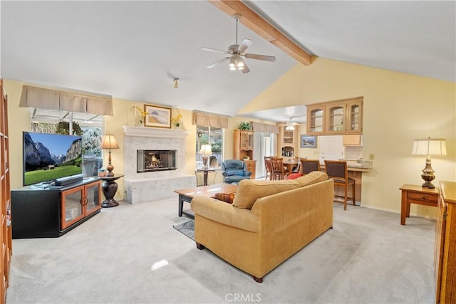 living room with carpet floors, lofted ceiling with beams, ceiling fan, and a fireplace