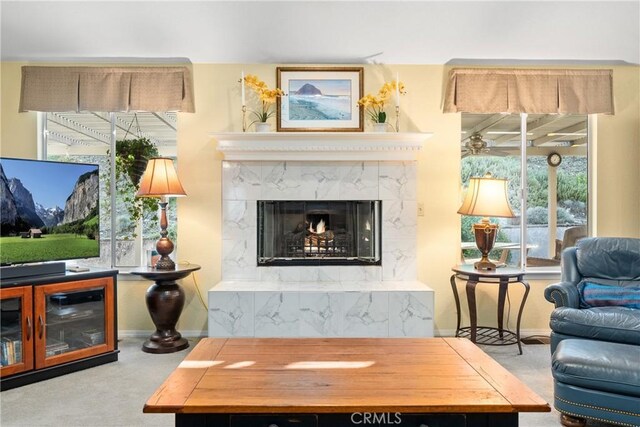 living area with carpet floors and a high end fireplace