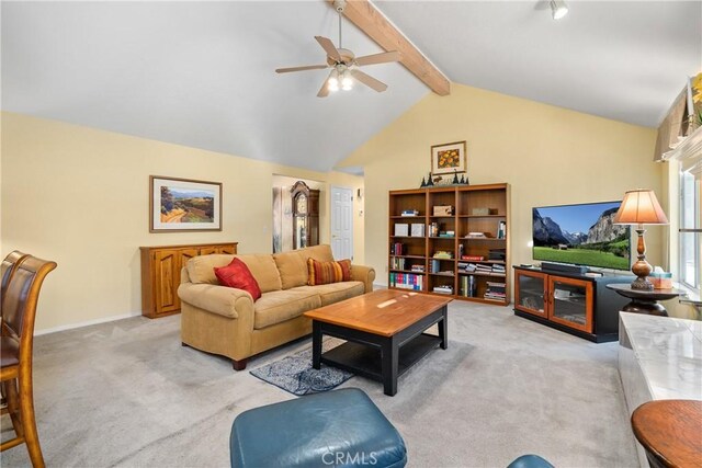 carpeted living room with ceiling fan and vaulted ceiling with beams