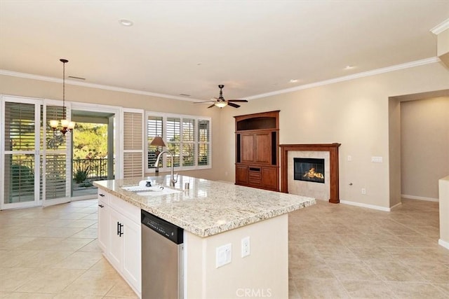 kitchen featuring baseboards, a premium fireplace, ornamental molding, a sink, and stainless steel dishwasher