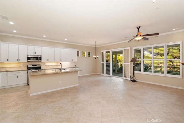 kitchen featuring a sink, crown molding, decorative backsplash, appliances with stainless steel finishes, and a kitchen island with sink