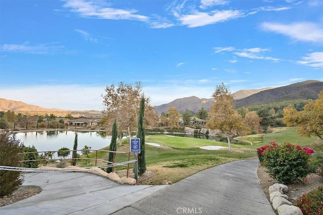 surrounding community featuring a yard and a water and mountain view