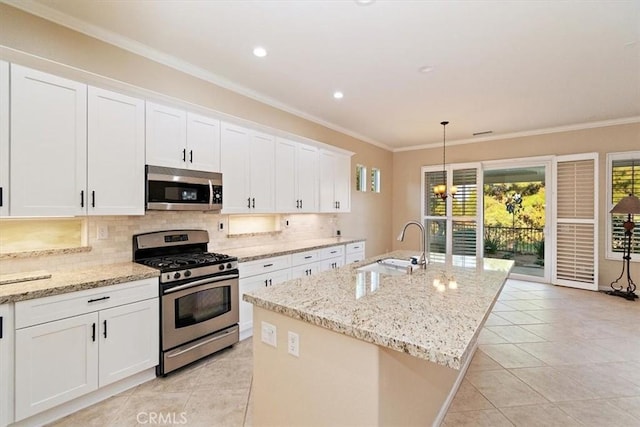 kitchen with ornamental molding, a sink, tasteful backsplash, appliances with stainless steel finishes, and white cabinets