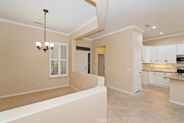 kitchen featuring white cabinets, appliances with stainless steel finishes, baseboards, and backsplash